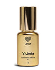 Gold bottle of 'Victoria' lash extension adhesive with 'LOVELY' branding on a white background