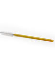 One gold-colored brushes with bristle heads on a white background